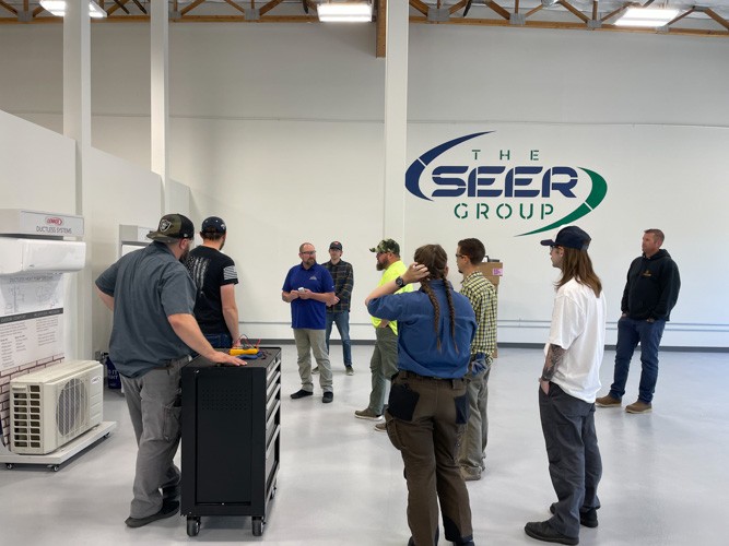 SEER Instructor teaching group of new technicians in front of Lennox ductless system